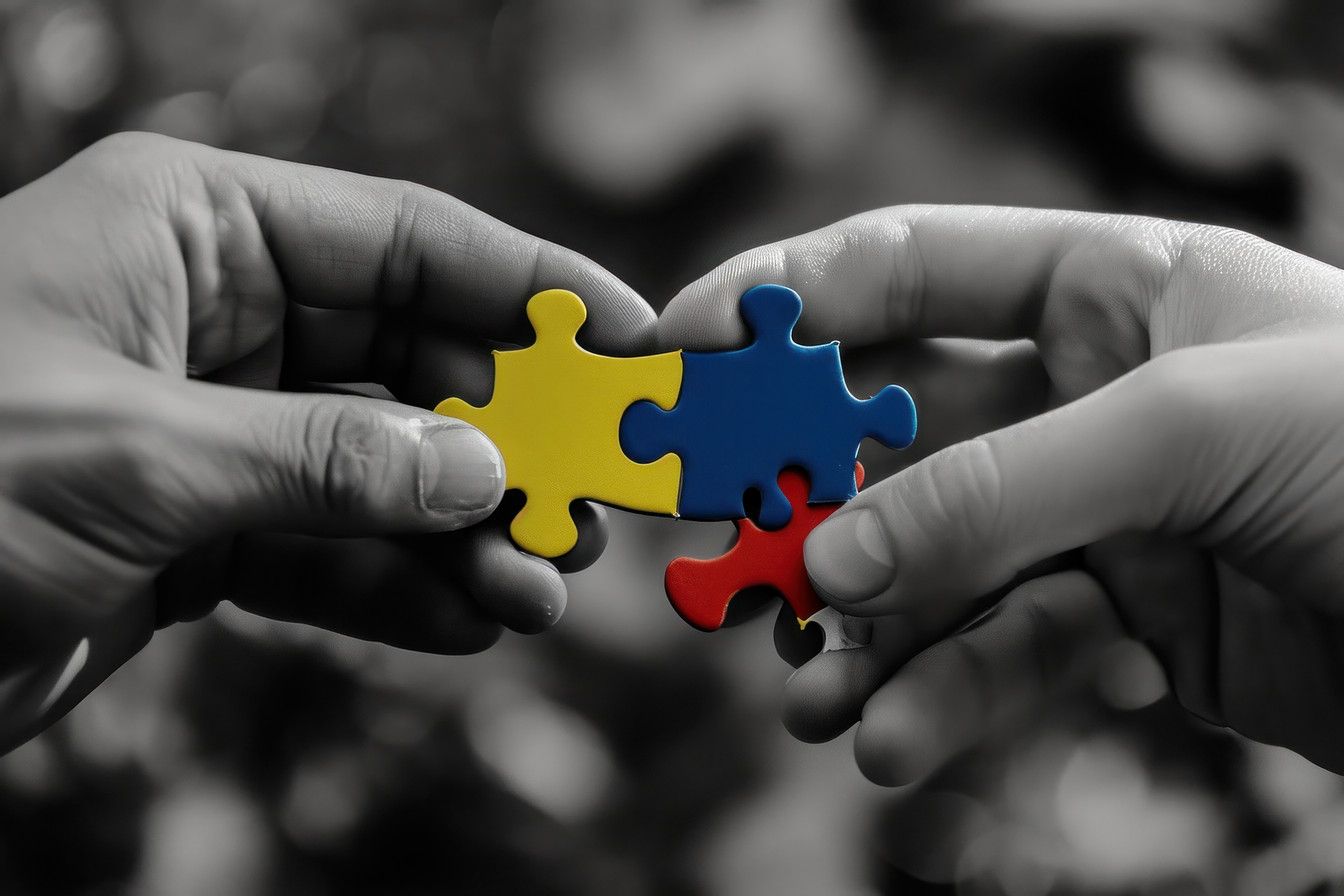 Hands connecting colorful puzzle pieces